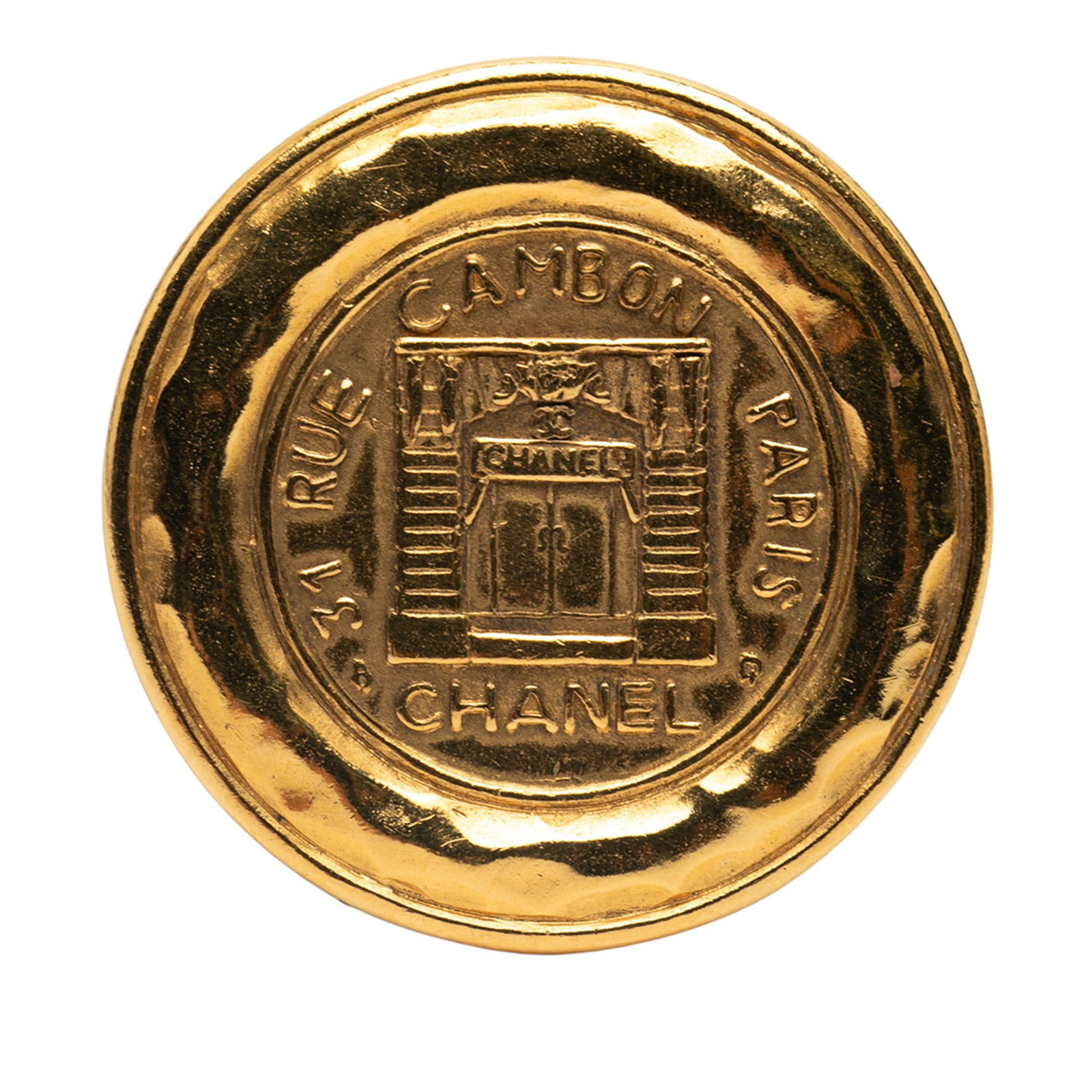 Chanel Vintage Gold Plated 31 Rue Cambon Round Brooch: Chanel Vintage Gold Plated 31 Rue Cambon Round Brooch This stunning vintage brooch by Chanel showcases a gold-plated metal body, elegantly designed in a round shape. It features a secure pin back clos