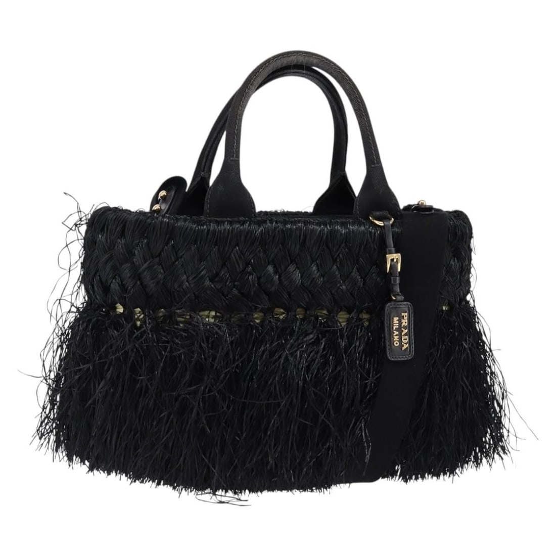 Black Wicker Tote with Fringe Detailing by Prada: Black Wicker Tote with Fringe Detailing by Prada This pre-owned Prada fringe wicker tote in black features a woven exterior with fringe detailing. The bag shows signs of use, including rubbing and sli