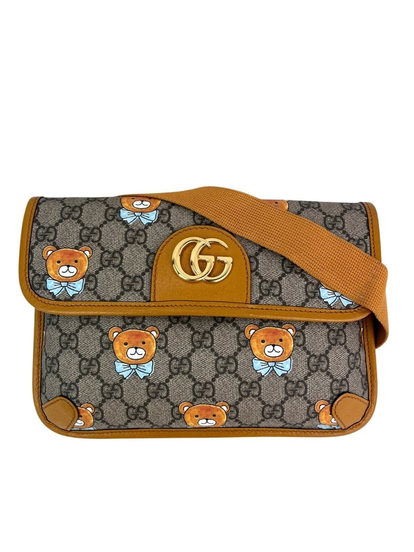 Gucci XKai GG Supreme Slim Bear Belt Sling Bag Brown Canvas: Gucci XKai GG Supreme Slim Bear Belt Sling Bag Brown Canvas Introducing the Gucci XKai GG Supreme Slim Vintage Sun Oil Bear Belt Sling Bag, a stylish and functional accessory perfect for casual travel
