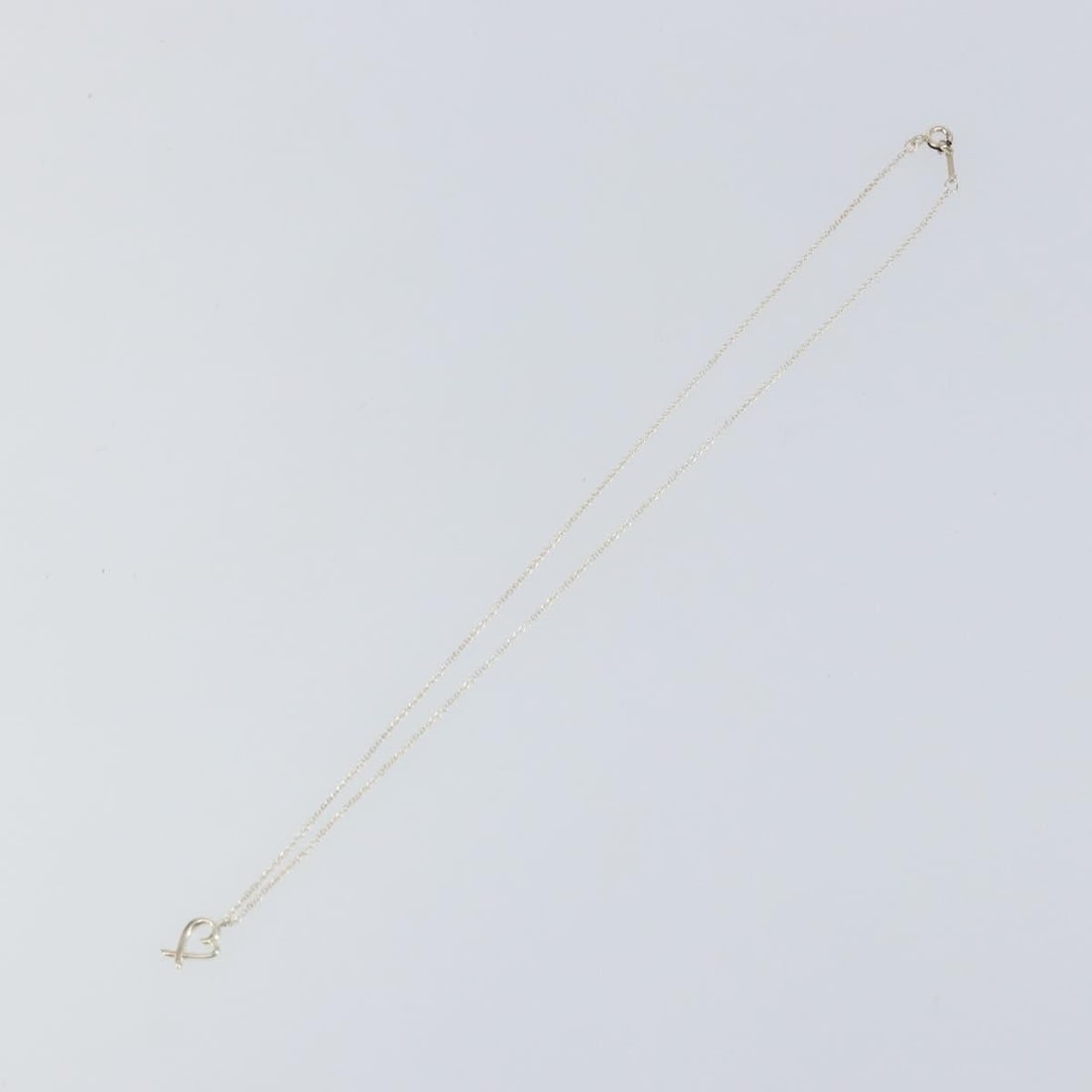 Paloma Picasso Loving Heart Silver Necklace by Tiffany & Co.: Paloma Picasso Loving Heart Silver Necklace by Tiffany & Co. This pre-owned Tiffany & Co. Paloma Picasso Loving Heart pendant necklace is crafted in silver and designed for female wearers. The necklac