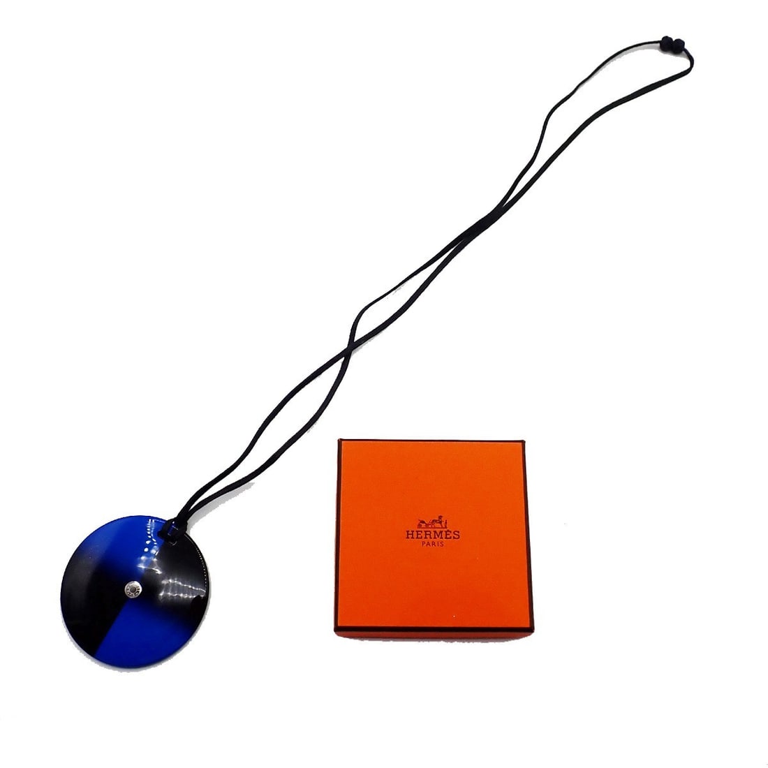 Buffalo Horn Necklace with Blue Accent by Hermes: Buffalo Horn Necklace with Blue Accent by Hermes This Hermes round necklace pendant features buffalo horn and blue accents, designed for female wearers. The piece is in excellent condition with minima