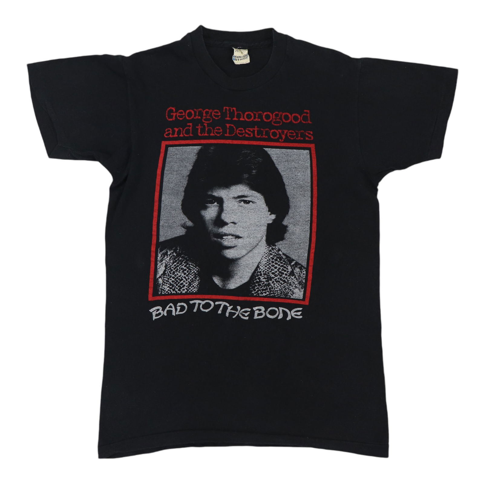 1985 George Thorogood Bad To The Bone Vintage Tour Shirt: 1985 George Thorogood Bad To The Bone Vintage Tour Shirt Discover a piece of rock history with this original vintage 1985 George Thorogood Bad To The Bone Tour Shirt. This authentic vintage shirt feat