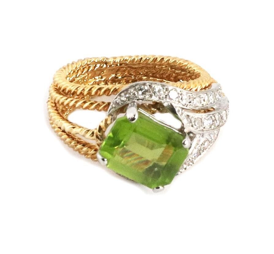 Hammerman Brothers 2.85ct Emerald Cut Peridot Diamond 18k Gold Ring: Hammerman Brothers 2.85ct Emerald Cut Peridot Diamond 18k Gold Ring This stunning ring by Hammerman Brothers showcases a unique design crafted from 18k yellow and white gold. It features a textured fi