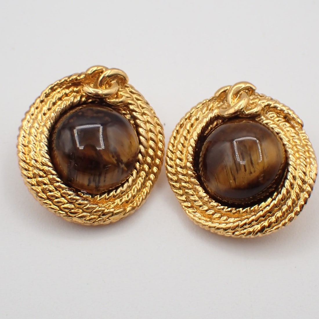 Round Brown Clip-On Earrings from Chanel Vintage Collection: Round Brown Clip-On Earrings from Chanel Vintage Collection These pre-owned Chanel vintage round clip-on earrings feature a classic design in brown. They are intended for female wearers and are in ver