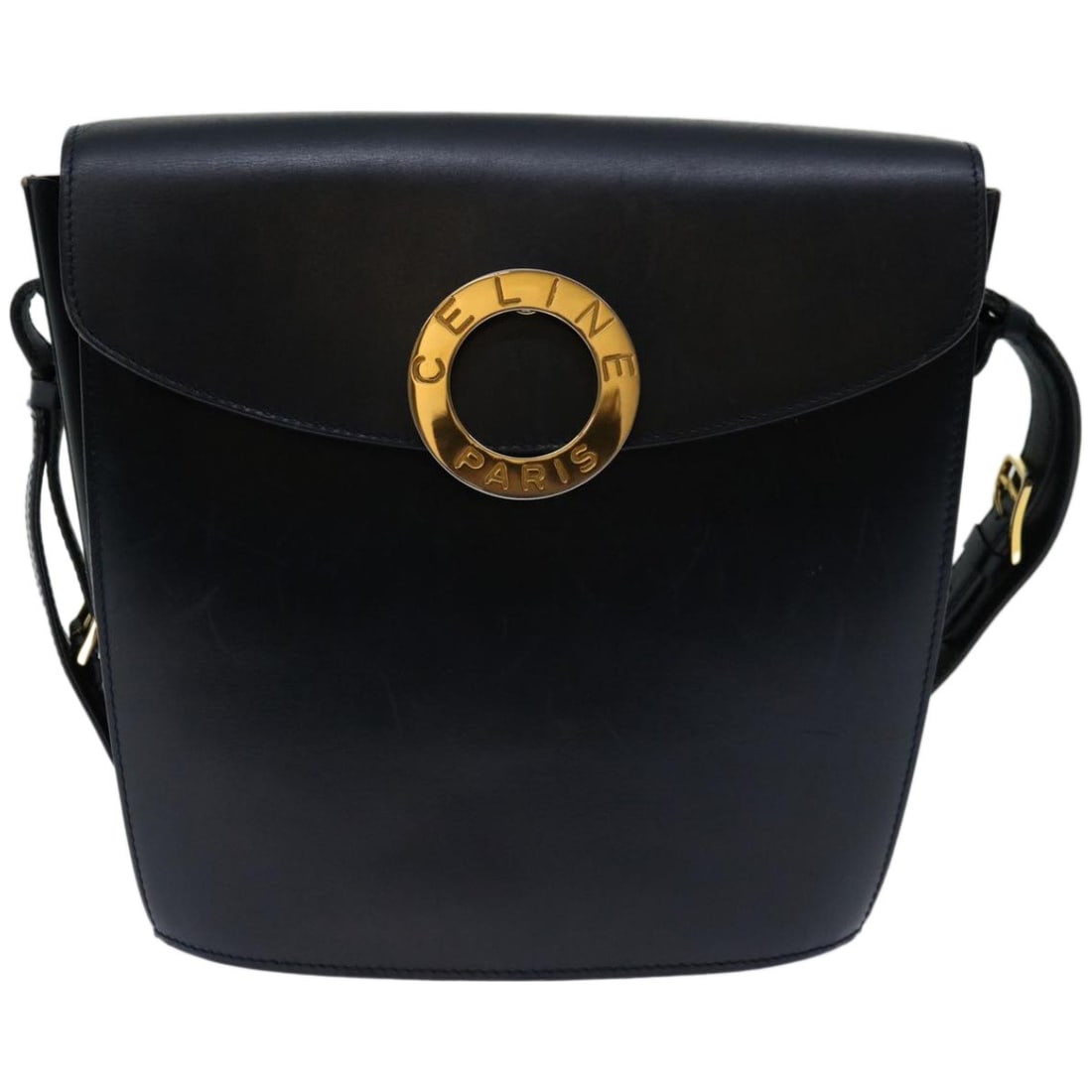 Vintage Celine Navy Crossbody Bag with Circle Emblem: Vintage Celine Navy Crossbody Bag with Circle Emblem This Celine Vintage Circle Logo crossbody bag features a navy exterior with the signature circle logo design. The bag shows slight rubbing on the o