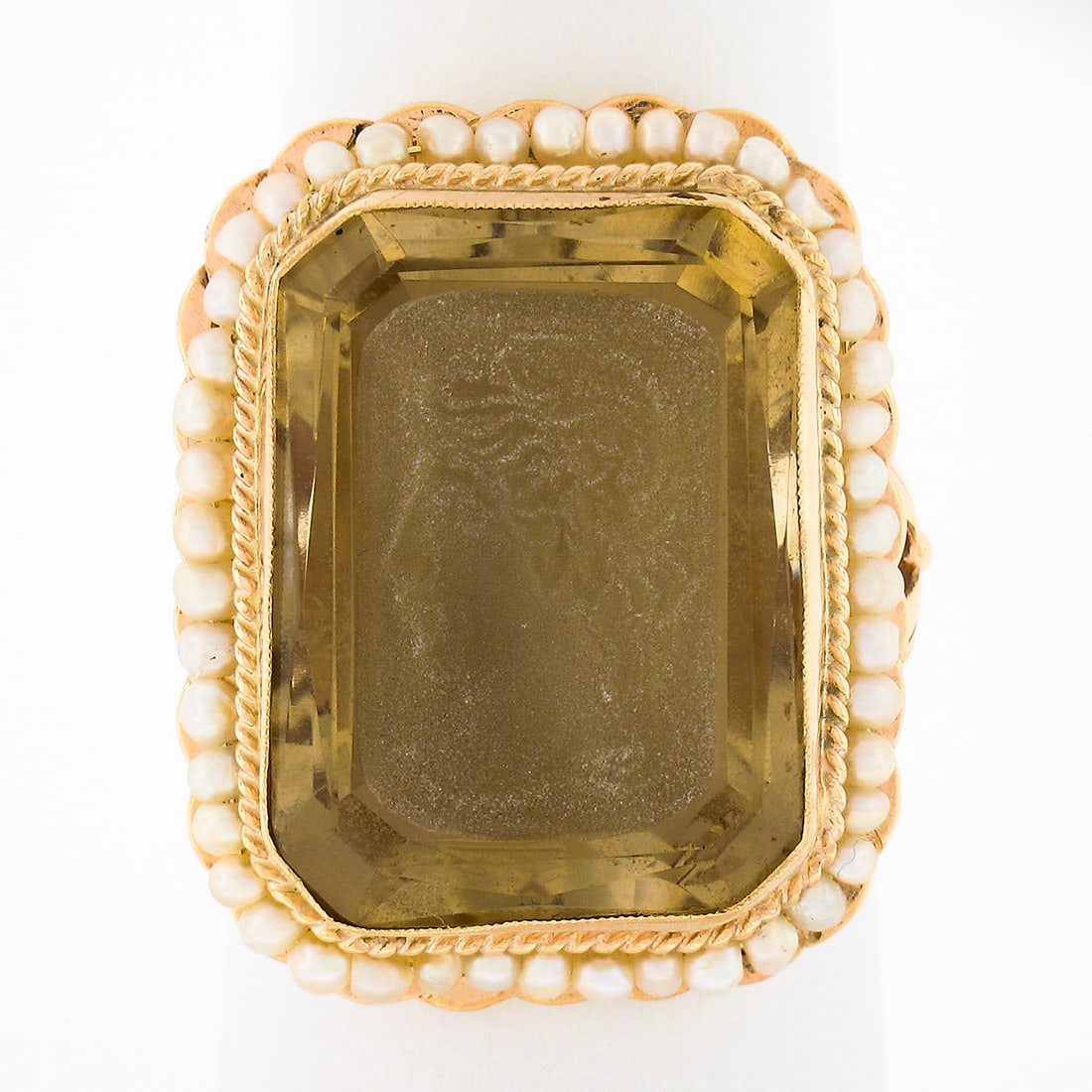 Vintage 14K Gold Citrine Intaglio Cameo Ring with Seed Pearl Halo: Vintage 14K Gold Citrine Intaglio Cameo Ring with Seed Pearl Halo This stunning vintage cocktail ring is crafted from solid 14K yellow gold, showcasing a large rectangular carved citrine intaglio at i
