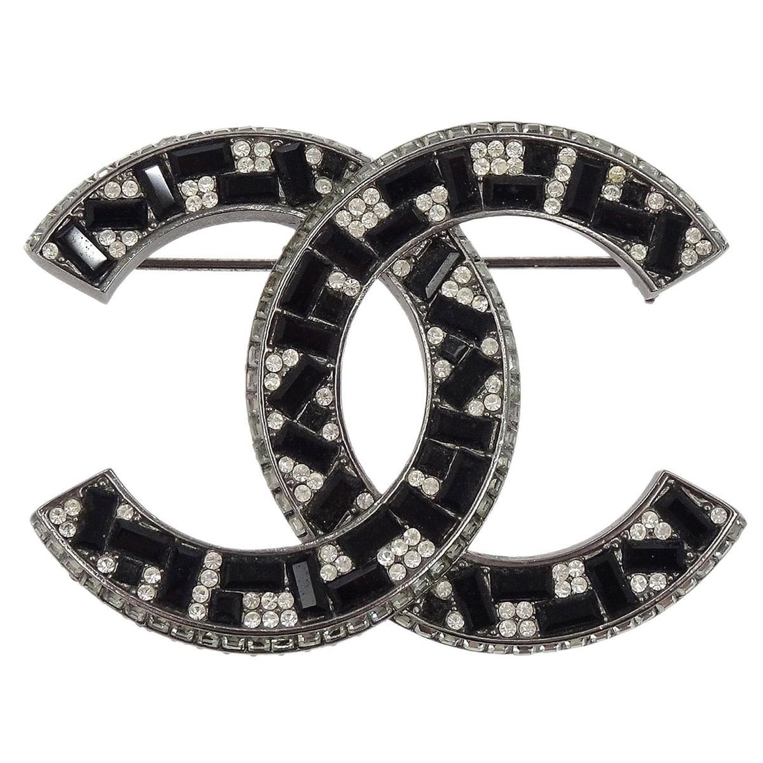 Silver Plated Brooch with CC Rhinestones by Chanel A15B: Silver Plated Brooch with CC Rhinestones by Chanel A15B This Chanel CC brooch features a classic design adorned with rhinestones, crafted in silver-plated metal. The piece showcases the iconic interlo