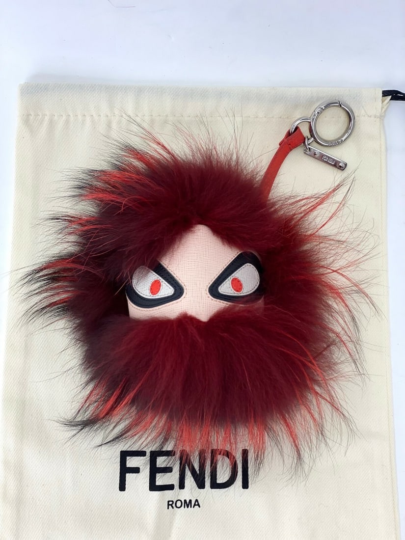 Fendi Red Bug Fur Leather Key Chain Bag Charm: Fendi Red Bug Fur Leather Key Chain Bag Charm Enhance your accessory collection with this Fendi Key Holder, featuring a playful bug design. This key chain is crafted from luxurious red fur leather, co