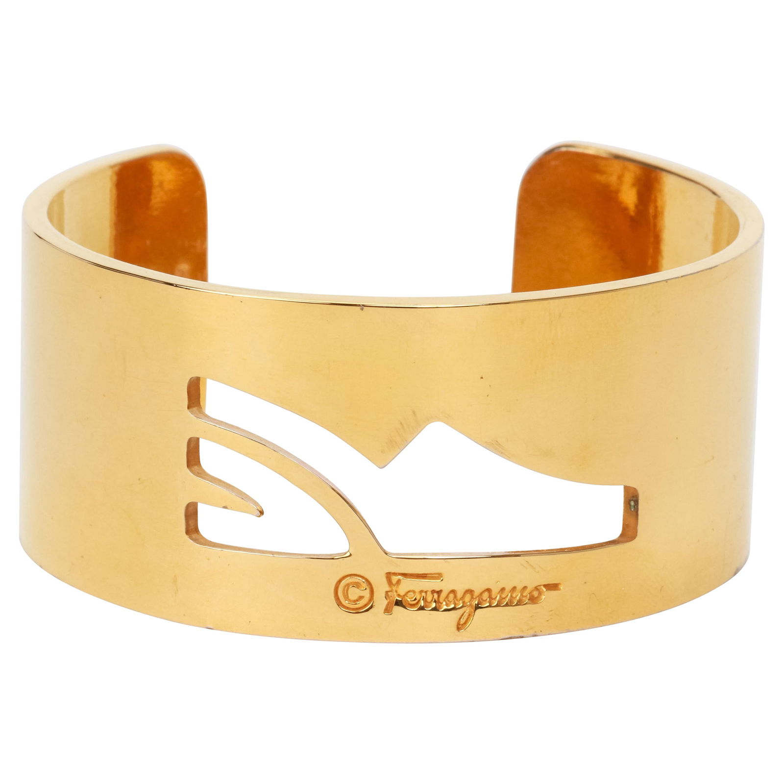 Vintage 1980s Ferragamo Gold Tone Cuff Bracelet with High Heel Design: Vintage 1980s Ferragamo Gold Tone Cuff Bracelet with High Heel Design This exquisite vintage 1980's Ferragamo cuff bracelet showcases a stunning gold tone finish. The unique design features a cutout s