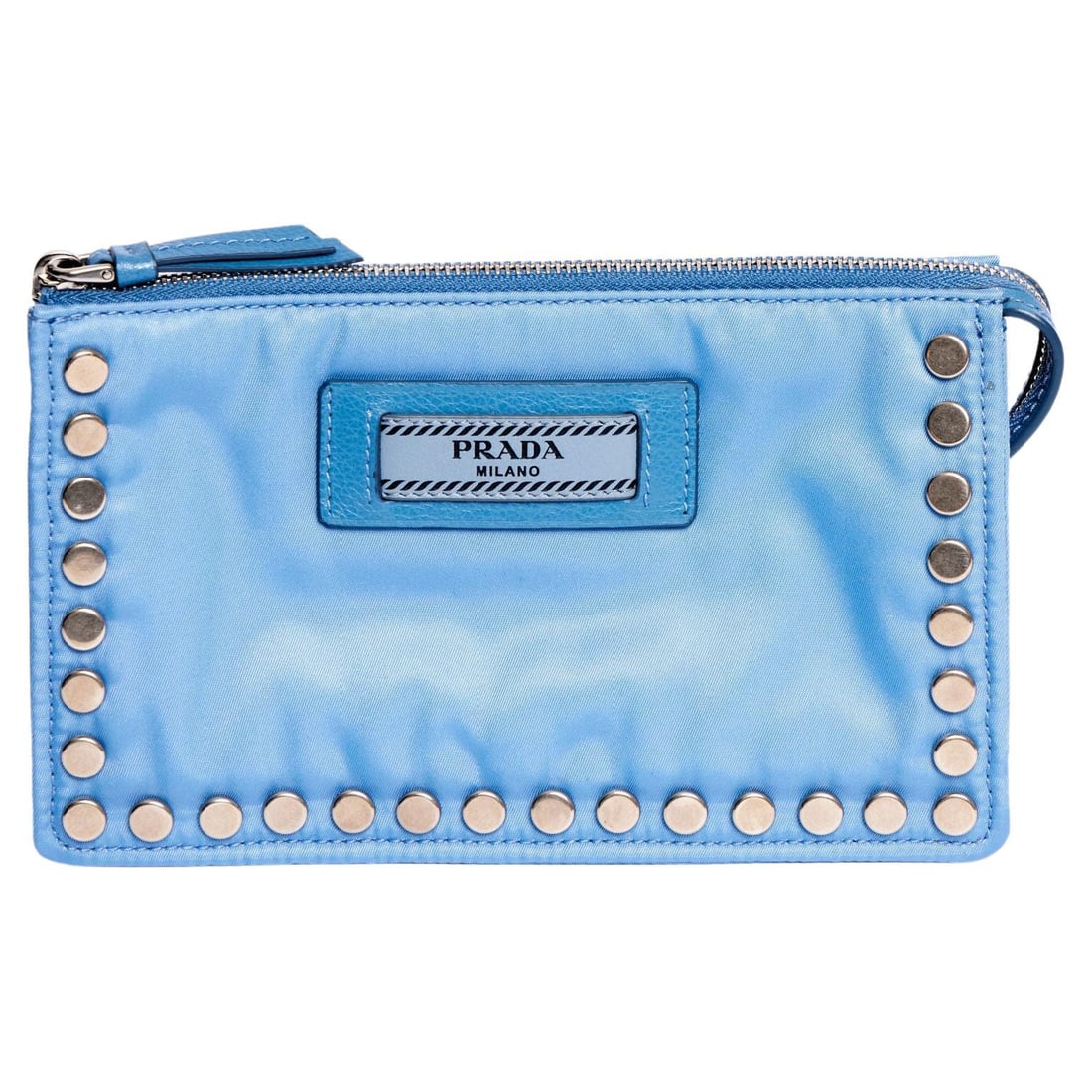 Prada Blue Fabric Studded Pouch with Authenticity Card: Prada Blue Fabric Studded Pouch with Authenticity Card This exquisite Prada pouch showcases a chic blue fabric exterior adorned with striking silver metal studs and a blue leather logo tag. Crafted in