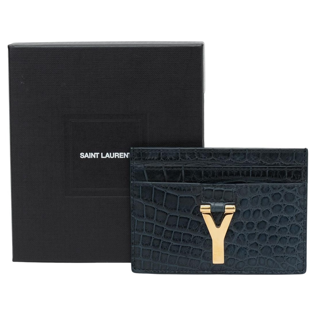 Yves Saint Laurent New Card Case Petroleum Crocodile Leather 5 Slots: Yves Saint Laurent New Card Case Petroleum Crocodile Leather 5 Slots Elegantly crafted by Yves Saint Laurent, this new card case showcases a stunning petroleum crocodile-embossed leather design. The l