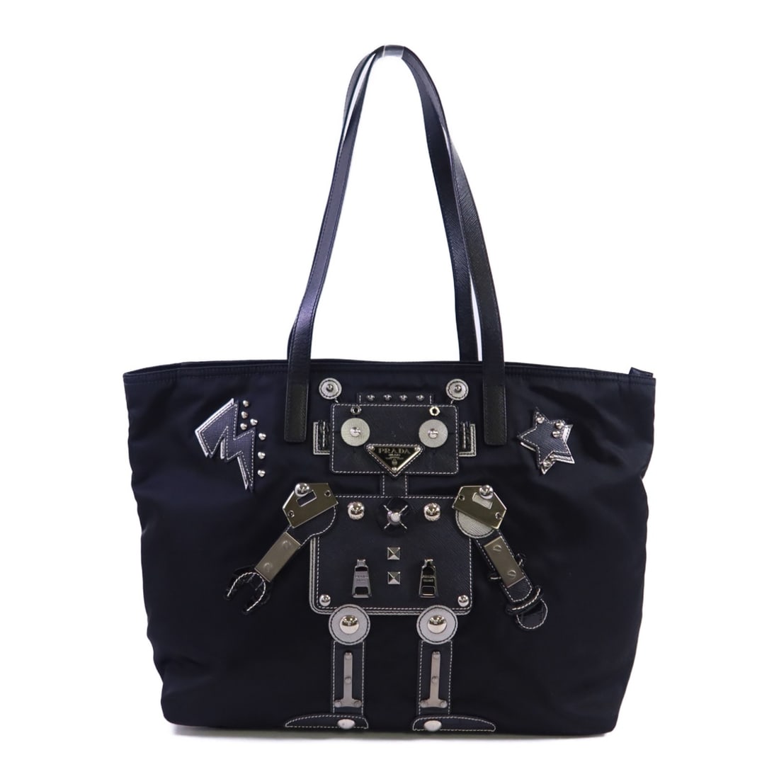 Prada Black Nylon Tote Shoulder Bag With Silver Tone Hardware: Prada Black Nylon Tote Shoulder Bag With Silver Tone Hardware This Prada tote bag is crafted from black nylon and features a structured silhouette with dual handles. Designed for versatile use as both