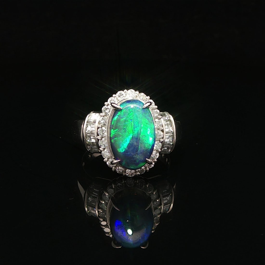 Platinum GIA Certified 2.93ct Black Opal Diamond Halo Ring: Platinum GIA Certified 2.93ct Black Opal Diamond Halo Ring This exquisite cocktail ring features a stunning 2.10ct natural genuine black opal, elegantly set in an oval double cabochon cut. The opal sh
