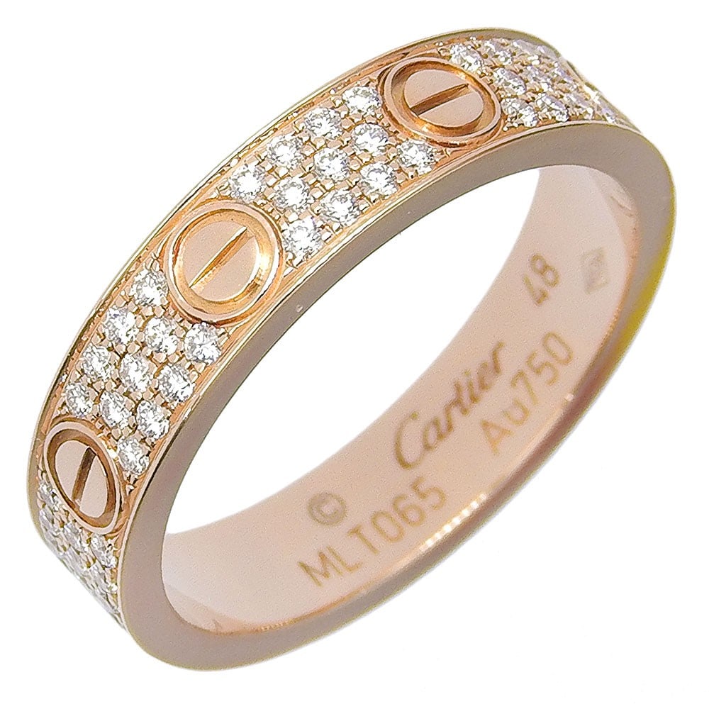 Cartier Love Band in Gold with Pave Diamond Accents: Cartier Love Band in Gold with Pave Diamond Accents This Cartier Love wedding band is crafted in gold and features a polished finish. The ring is adorned with pave-set diamonds and is designed for wom