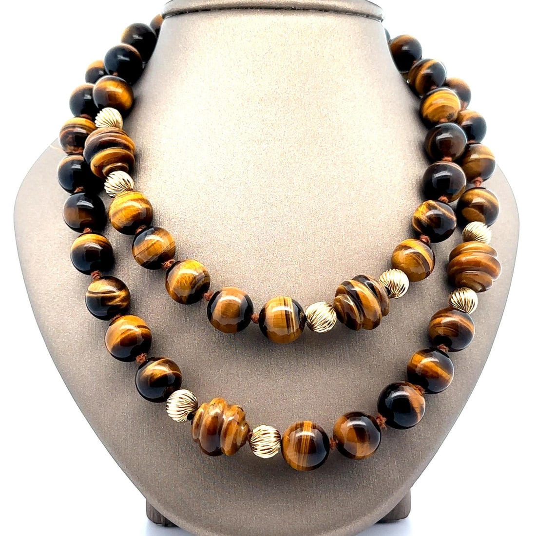 36 Inch Tiger's Eye Bead Necklace with 14k Gold Accents: 36 Inch Tiger's Eye Bead Necklace with 14k Gold Accents This stunning 36-inch long beaded necklace showcases the natural beauty of Tiger's Eye stones. It features a combination of (50) round stones, m