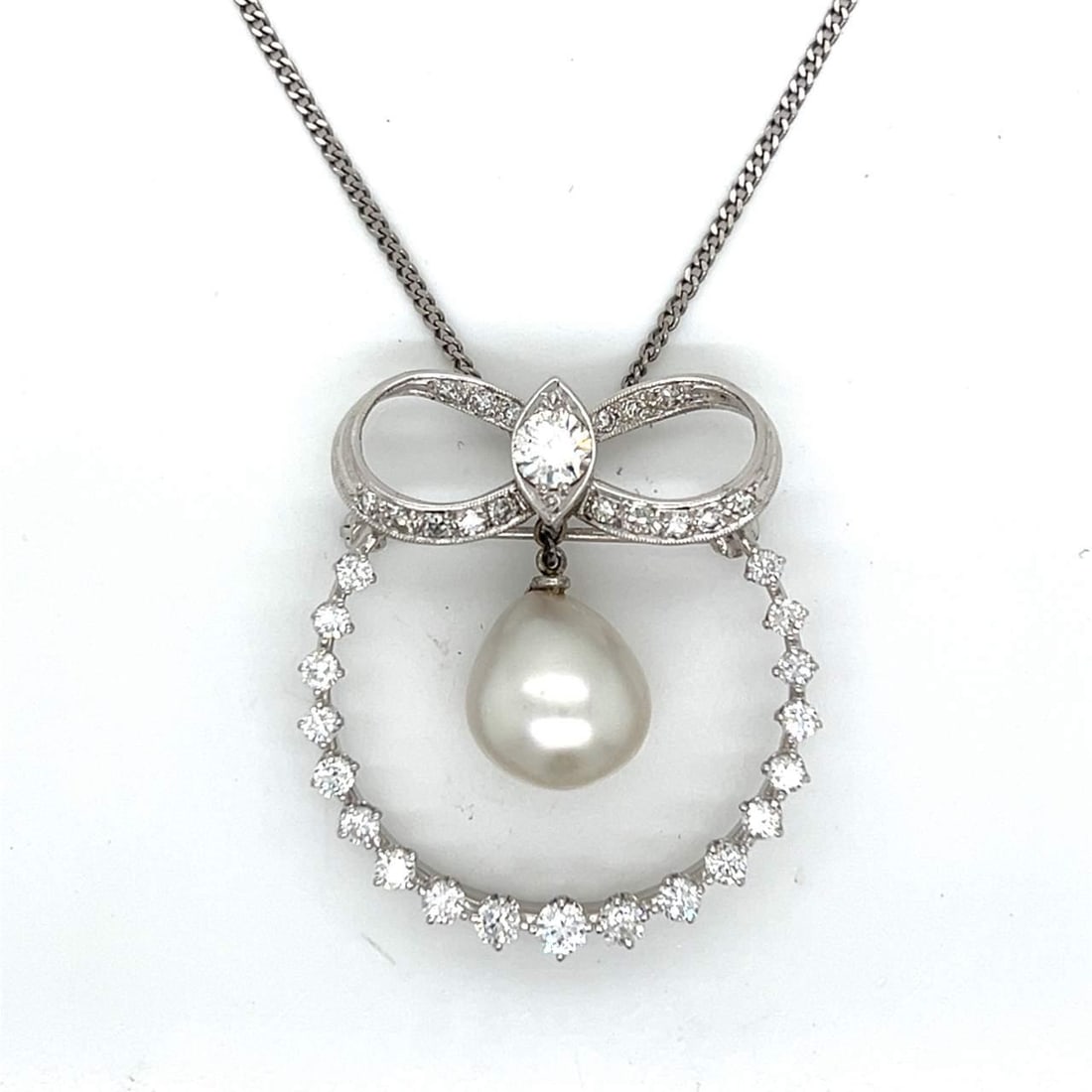 1950's Platinum Necklace with 12.2mm South Sea Pearl and 36 Diamonds: 1950's Platinum Necklace with 12.2mm South Sea Pearl and 36 Diamonds This exquisite 1950's necklace is crafted from platinum and features a stunning 12.2mm South Sea pearl surrounded by 36 sparkling d