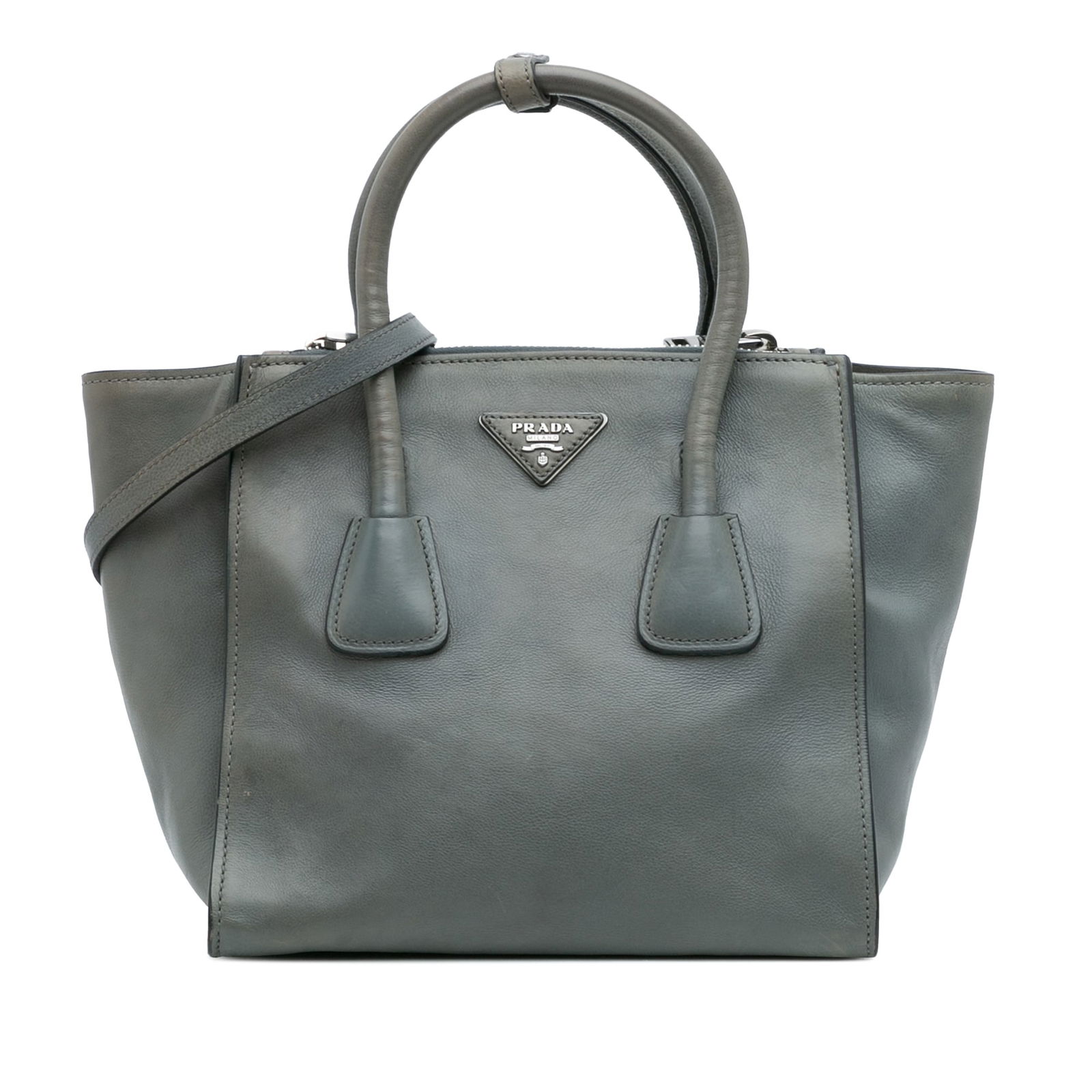 Prada Glace Calf Twin Pocket Satchel Gray Leather Bag: Prada Glace Calf Twin Pocket Satchel Gray Leather Bag The Prada Glace Calf Twin Pocket Satchel is an elegant accessory crafted from high-quality leather. It features rolled leather handles and a detac