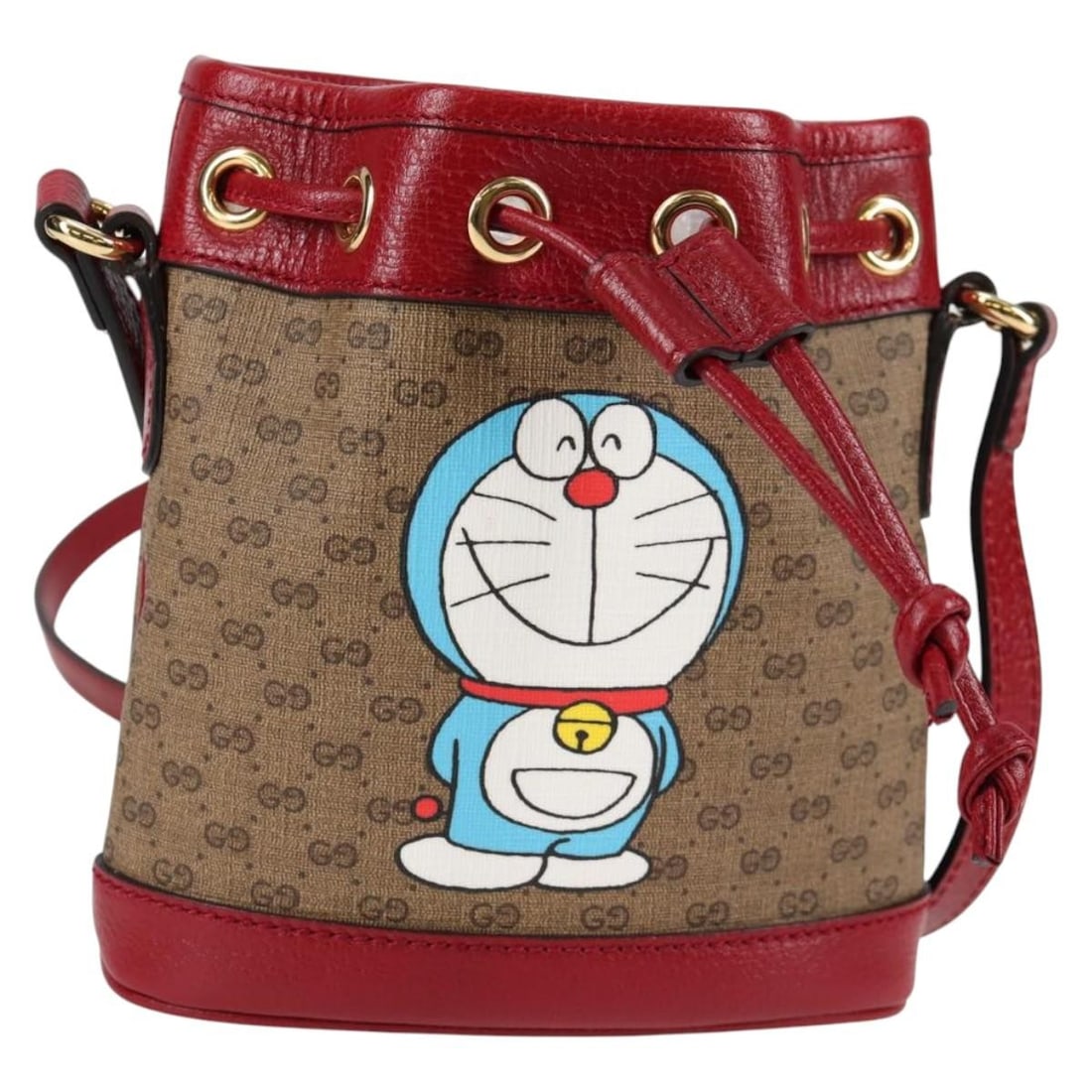 Doraemon Collaboration Beige Bucket Bag by Gucci: Doraemon Collaboration Beige Bucket Bag by Gucci This Gucci Doraemon bucket bag features a beige exterior in excellent condition with no significant scratches. The shoulder strap shows slight loss of