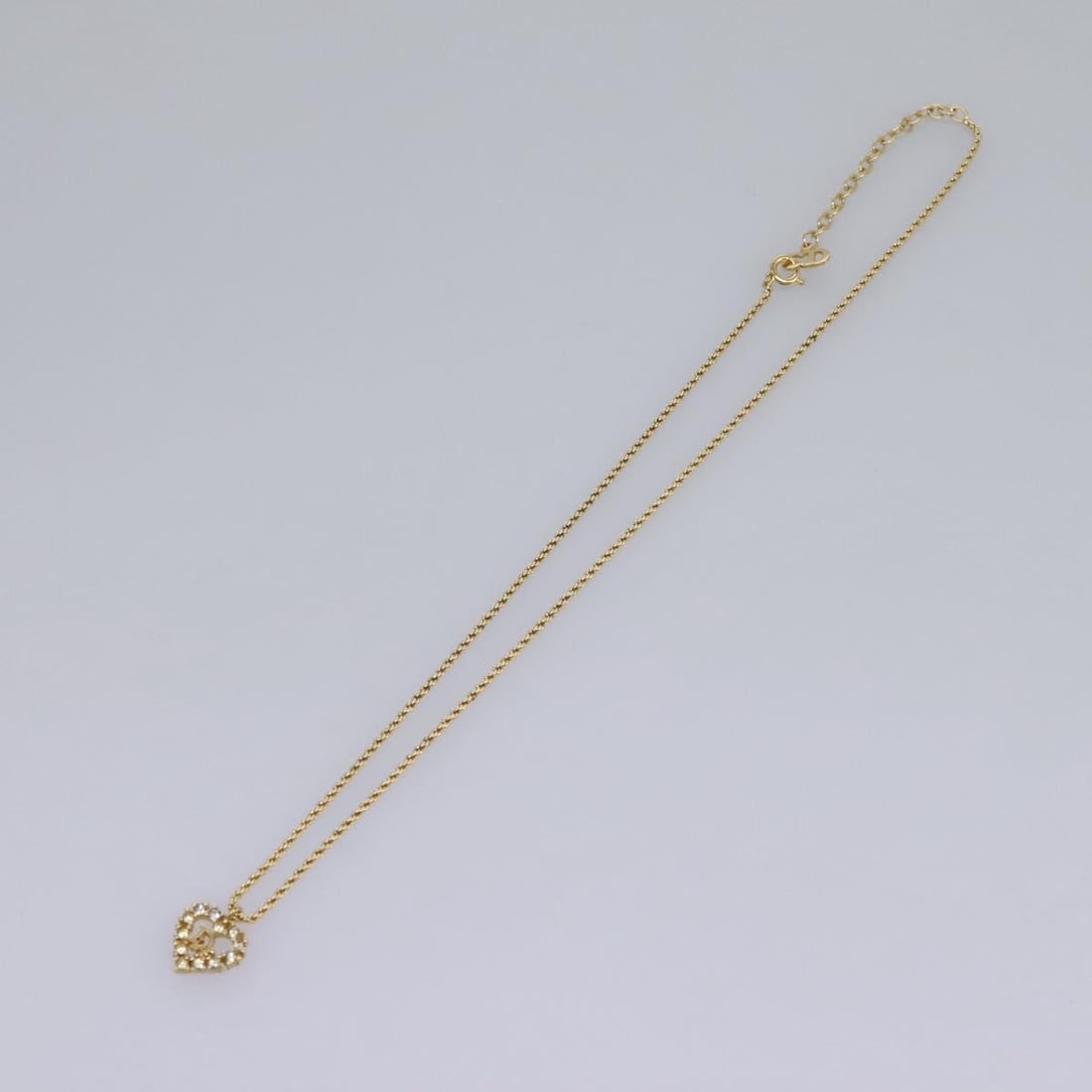 Heart Pendant Necklace with Christian Dior Logo Gold Tone: Heart Pendant Necklace with Christian Dior Logo Gold Tone This Christian Dior necklace features a heart-shaped pendant with the iconic Dior logo and a gold-tone finish. The necklace is designed for wo