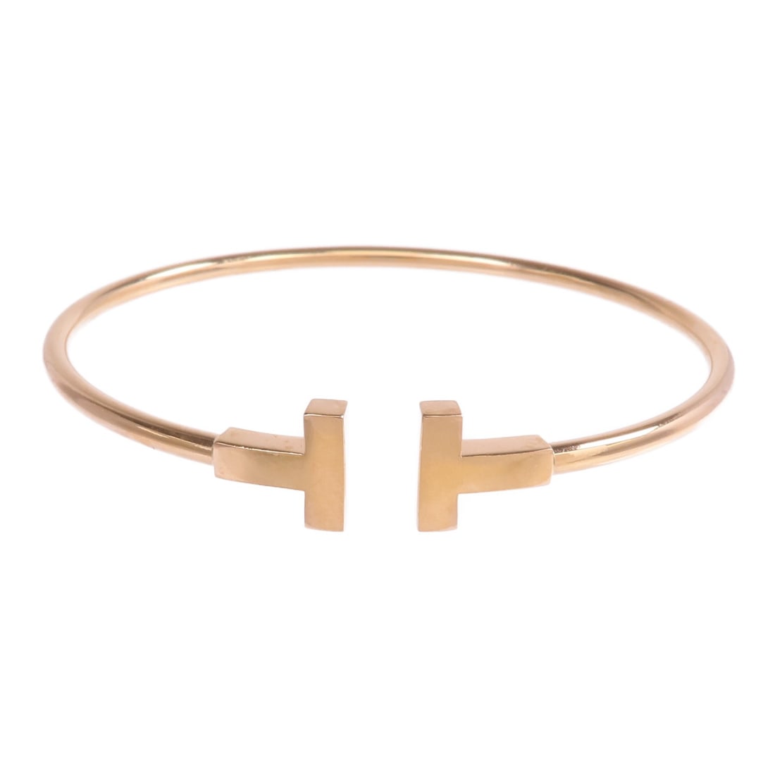 T Wire 18K Rose Gold Bracelet by Tiffany and Co: T Wire 18K Rose Gold Bracelet by Tiffany and Co This is a Tiffany & Co. T Wire bracelet crafted from 18K pink gold. The bracelet has a regular size type and features a classic, minimalist design witho
