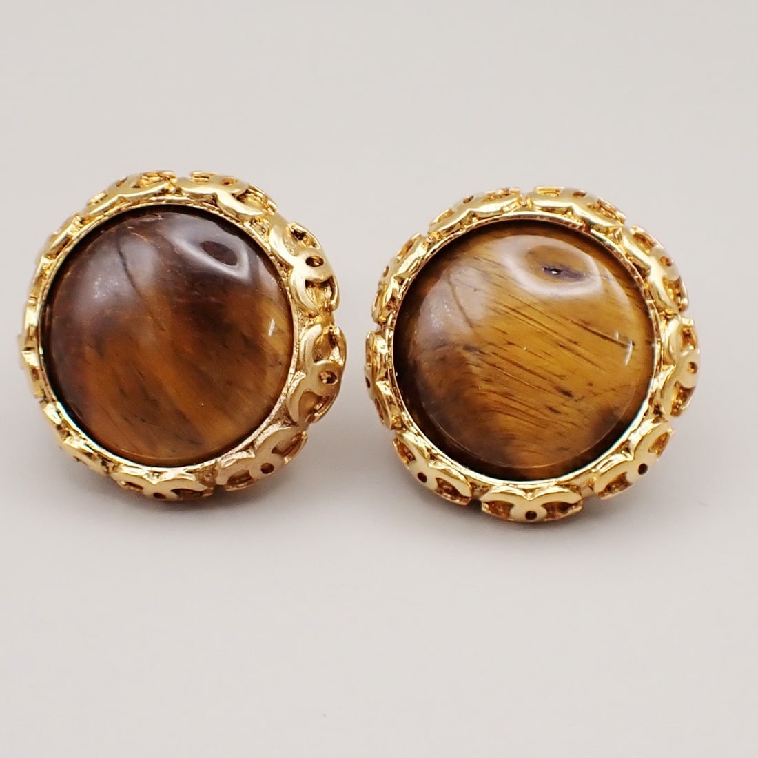 Vintage Chanel Gold Tone CC Clip On Button Earrings: Vintage Chanel Gold Tone CC Clip On Button Earrings Chanel vintage CC round button clip-on earrings in gold tone. These earrings are designed for women and are in excellent condition with minor scuffs