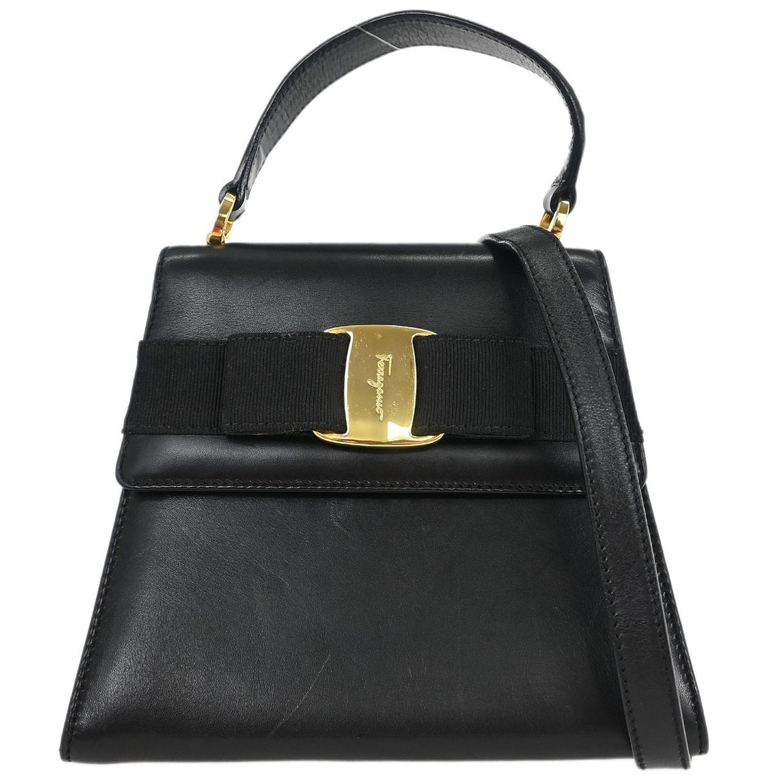Black Leather Vara Bow Top Handle Bag by Salvatore Ferragamo: Black Leather Vara Bow Top Handle Bag by Salvatore Ferragamo This Salvatore Ferragamo handbag features black leather with a signature Vara bow accent. Designed for versatility, it can be carried as a