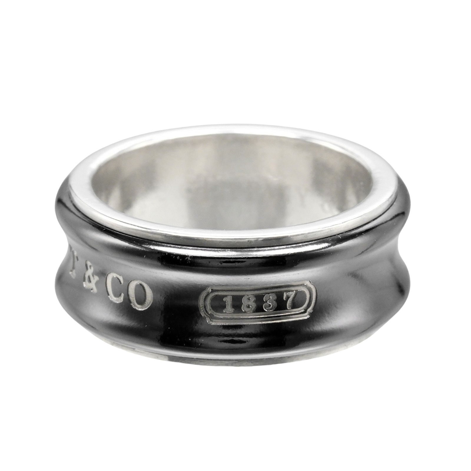 1837 Collection Silver Band Ring by Tiffany & Co.: 1837 Collection Silver Band Ring by Tiffany & Co. This pre-owned Tiffany & Co. 1837 band ring is crafted from silver and designed for women. It features subtle signs of wear, such as minor scratches a