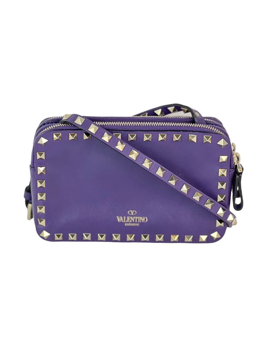 Valentino Rockstud Double Zip Purple Leather Crossbody Bag with Gold Accents: Valentino Rockstud Double Zip Purple Leather Crossbody Bag with Gold Accents Introducing the Valentino Rockstud Double Zip Crossbody Bag in a stunning purple leather finish. This small, rectangular ba