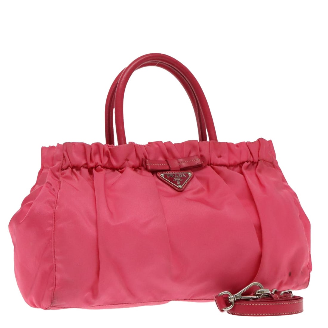 Pink Prada Convertible Tote with Bow Detail: Pink Prada Convertible Tote with Bow Detail This Prada Bow Convertible Tote in pink features a spacious design with both handles and a detachable shoulder strap for versatile carrying options. The bag