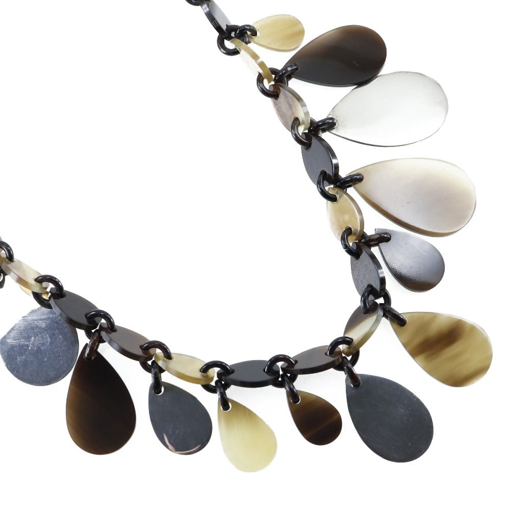 Buffalo Horn Pendant Necklace by Hermes in Brown: Buffalo Horn Pendant Necklace by Hermes in Brown Hermes necklace crafted from buffalo horn in a brown finish. This jewelry piece is designed for women and shows scratches, discoloration, and noticeabl