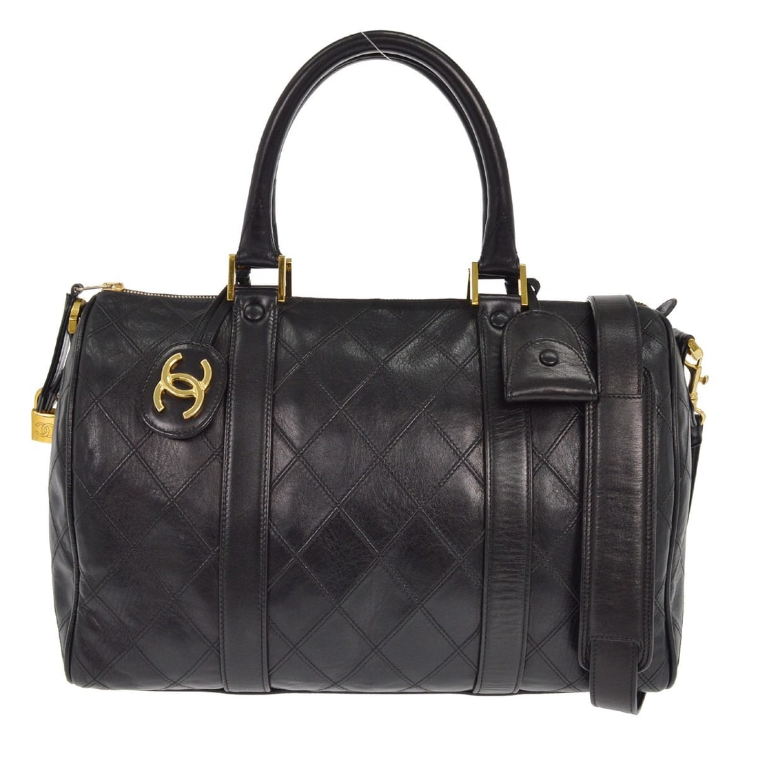 Black Diamond Stitch Boston Travel Bag by Chanel Vintage: Black Diamond Stitch Boston Travel Bag by Chanel Vintage This Chanel Vintage Diamond Stitch Boston Bag features a black exterior with a classic diamond stitch pattern. The bag is designed for women an
