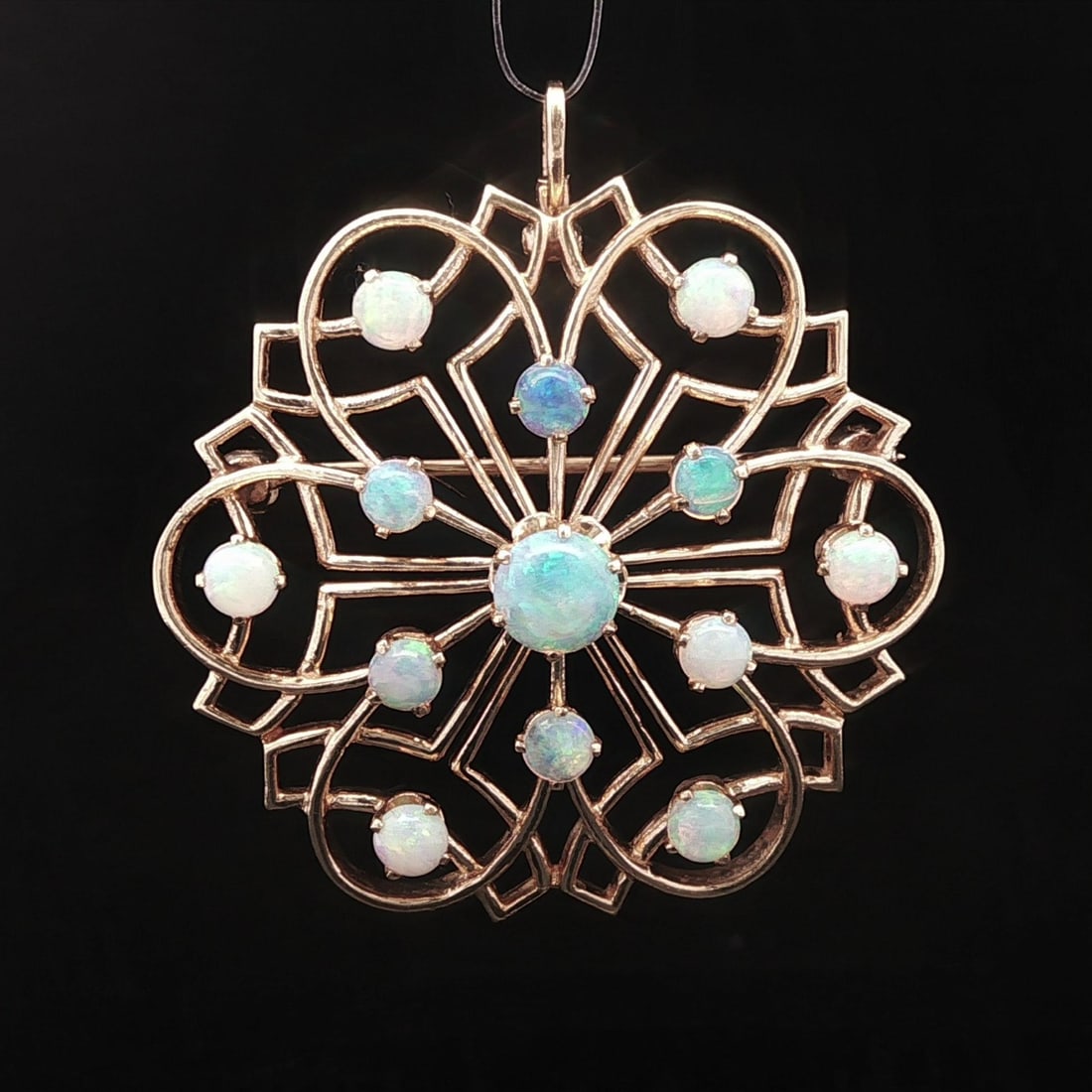 Vintage 13-14K Yellow Gold Opal Brooch with Natural Gemstones: Vintage 13-14K Yellow Gold Opal Brooch with Natural Gemstones This exquisite vintage brooch pendant features a stunning design crafted from solid 13-14K yellow gold. Adorning the piece are thirteen na