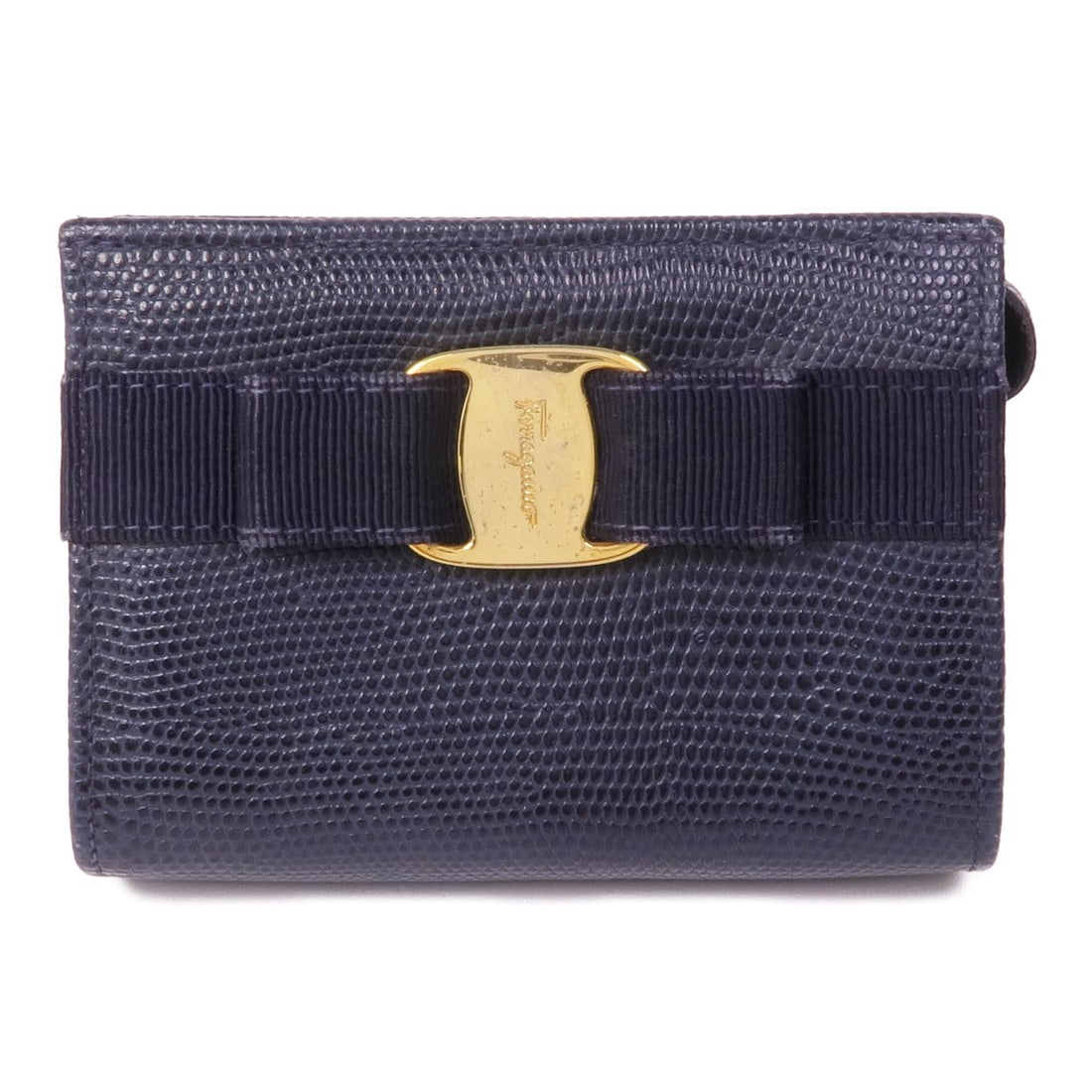 Salvatore Ferragamo Navy Embossed Leather Coin Purse GHW: Salvatore Ferragamo Navy Embossed Leather Coin Purse GHW This elegant Salvatore Ferragamo coin purse is crafted from high-quality embossed leather, showcasing a sophisticated navy color. Designed for