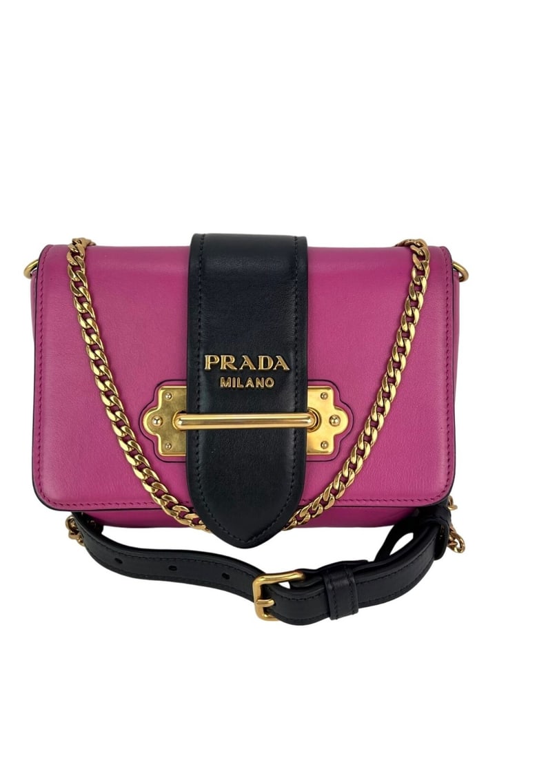 Prada City Calf Cahier Pink Black Leather Crossbody Bag with Gold Hardware: Prada City Calf Cahier Pink Black Leather Crossbody Bag with Gold Hardware Elevate your accessory game with the Prada City Calf Cahier Crossbody Belt Bag in a chic pink and black leather design. This