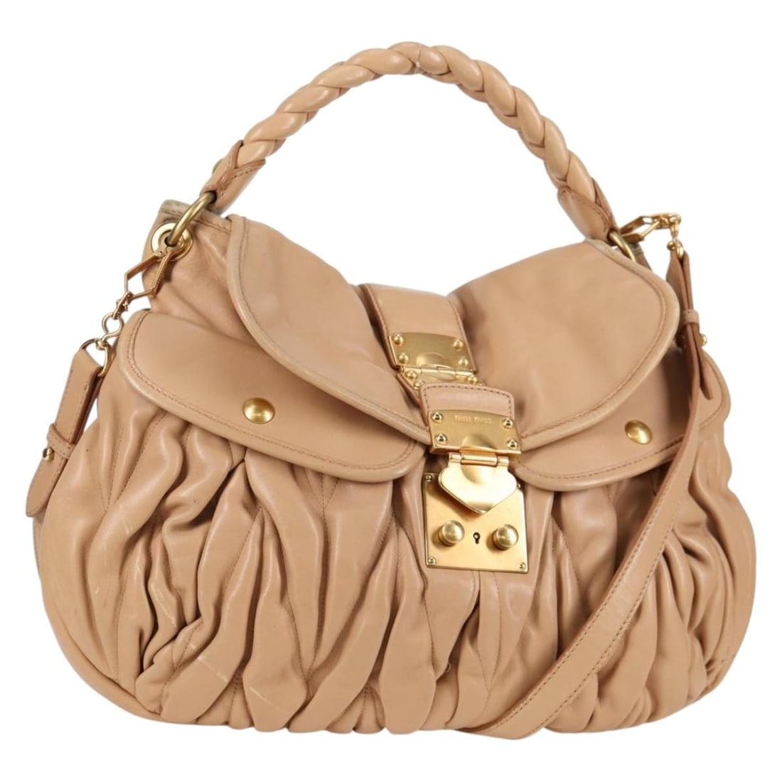 Beige Coffer Convertible Hobo Handbag by Miu Miu: Beige Coffer Convertible Hobo Handbag by Miu Miu This Miu Miu Coffer Convertible Hobo handbag is crafted in beige and designed for women. The bag shows signs of gentle use, including some loss of shap