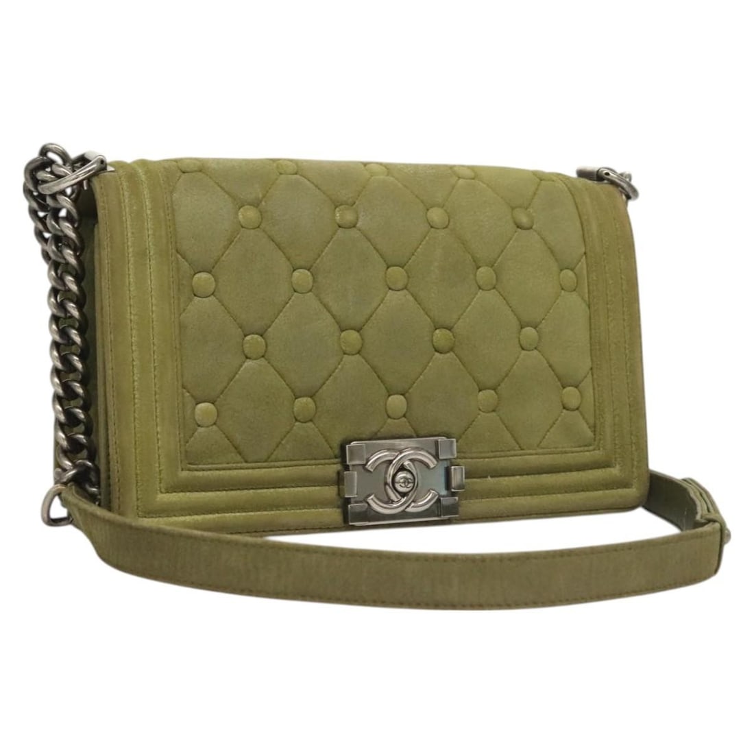 Green Celtic Boy Shoulder Bag by Chanel: Green Celtic Boy Shoulder Bag by Chanel This pre-owned Chanel Celtic Boy Flap Bag features a green exterior and is designed as a shoulder bag for women. It shows signs of use, including rubbing and st