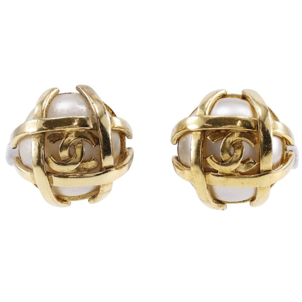 Gold Tone Vintage CC Earrings by Chanel: Gold Tone Vintage CC Earrings by Chanel These vintage Chanel CC earrings feature a gold-tone finish and showcase the iconic CC logo. Designed for women, the earrings exhibit signs of wear, including p