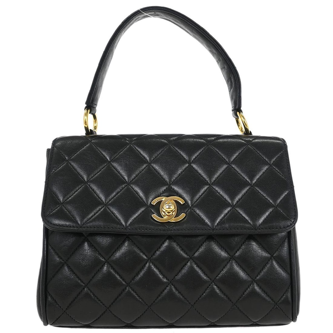 Small Chanel Lambskin Leather Top Handle Flap Bag in Black: Small Chanel Lambskin Leather Top Handle Flap Bag in Black This Chanel handbag features black lambskin leather in a straight flap design. The top handle style provides a classic and elegant look, whil