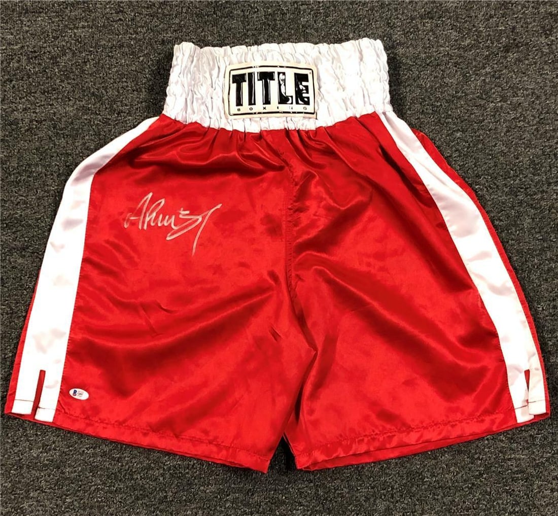Andy Ruiz Jr Signed Red Boxing Trunks with Beckett COA: Andy Ruiz Jr Signed Red Boxing Trunks with Beckett COA Own a piece of boxing history with these authentic red boxing trunks signed by the first Mexican heavyweight champion, Andy Ruiz Jr. These shorts