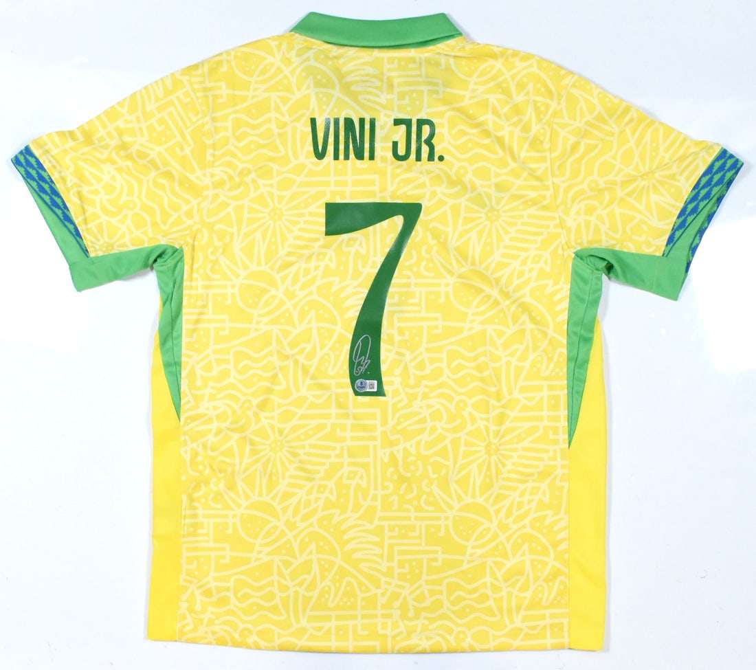 Vini Jr. Signed Brazil FC Yellow Jersey #7 with Beckett Hologram: Vini Jr. Signed Brazil FC Yellow Jersey #7 with Beckett Hologram Celebrate the spirit of Brazilian football with this original signed jersey from Vini Jr., featuring the iconic yellow color of the Bra