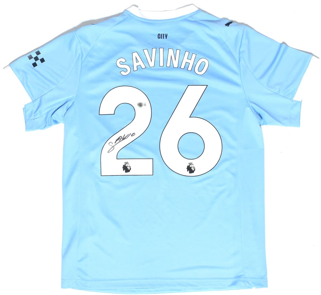Savinho Signed Manchester City Home Jersey #26 Beckett Holo XL: Savinho Signed Manchester City Home Jersey #26 Beckett Holo XL This is an original autographed Manchester City home soccer jersey featuring the signature of player Savinho. The jersey is a size XL and