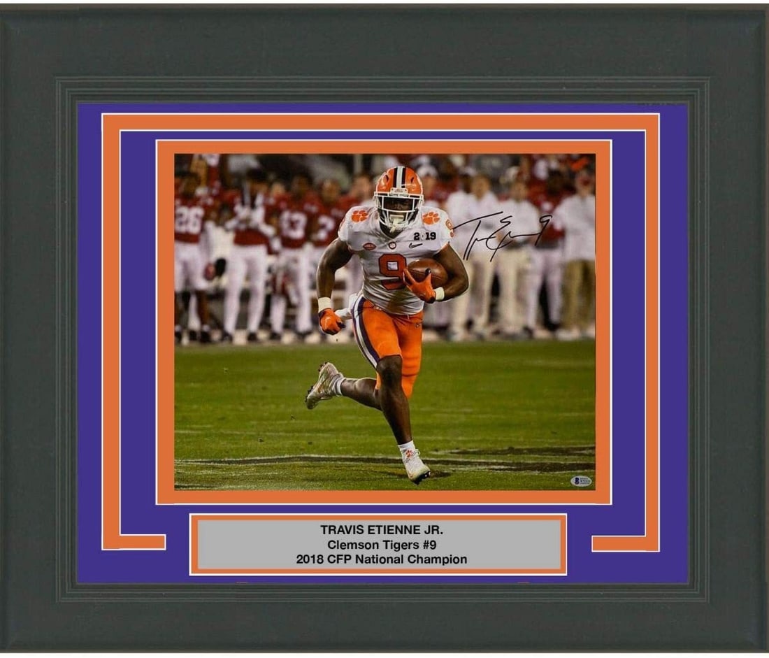 Framed Autographed Travis Etienne Jr Clemson 16x20 Photo Beckett COA Gem Mint: Framed Autographed Travis Etienne Jr Clemson 16x20 Photo Beckett COA Gem Mint This professionally framed and matted 16x20 photo of Travis Etienne Jr., a standout player for the Clemson Tigers, feature