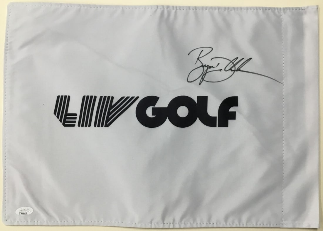 Bryson DeChambeau LIV 18 Signed Flag JSA Authenticated AV66432: Bryson DeChambeau LIV 18 Signed Flag JSA Authenticated AV66432 Celebrate your passion for golf with this officially licensed LIV 18 pin flag, signed by PGA star Bryson DeChambeau. This unique collecto