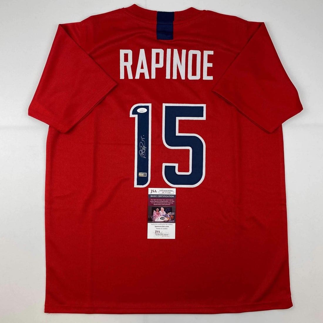 Signed Megan Rapinoe Red Soccer Jersey USA JSA Authenticated: Signed Megan Rapinoe Red Soccer Jersey USA JSA Authenticated This is an autographed red soccer jersey of Megan Rapinoe, a prominent athlete representing the United States. The jersey is an original co