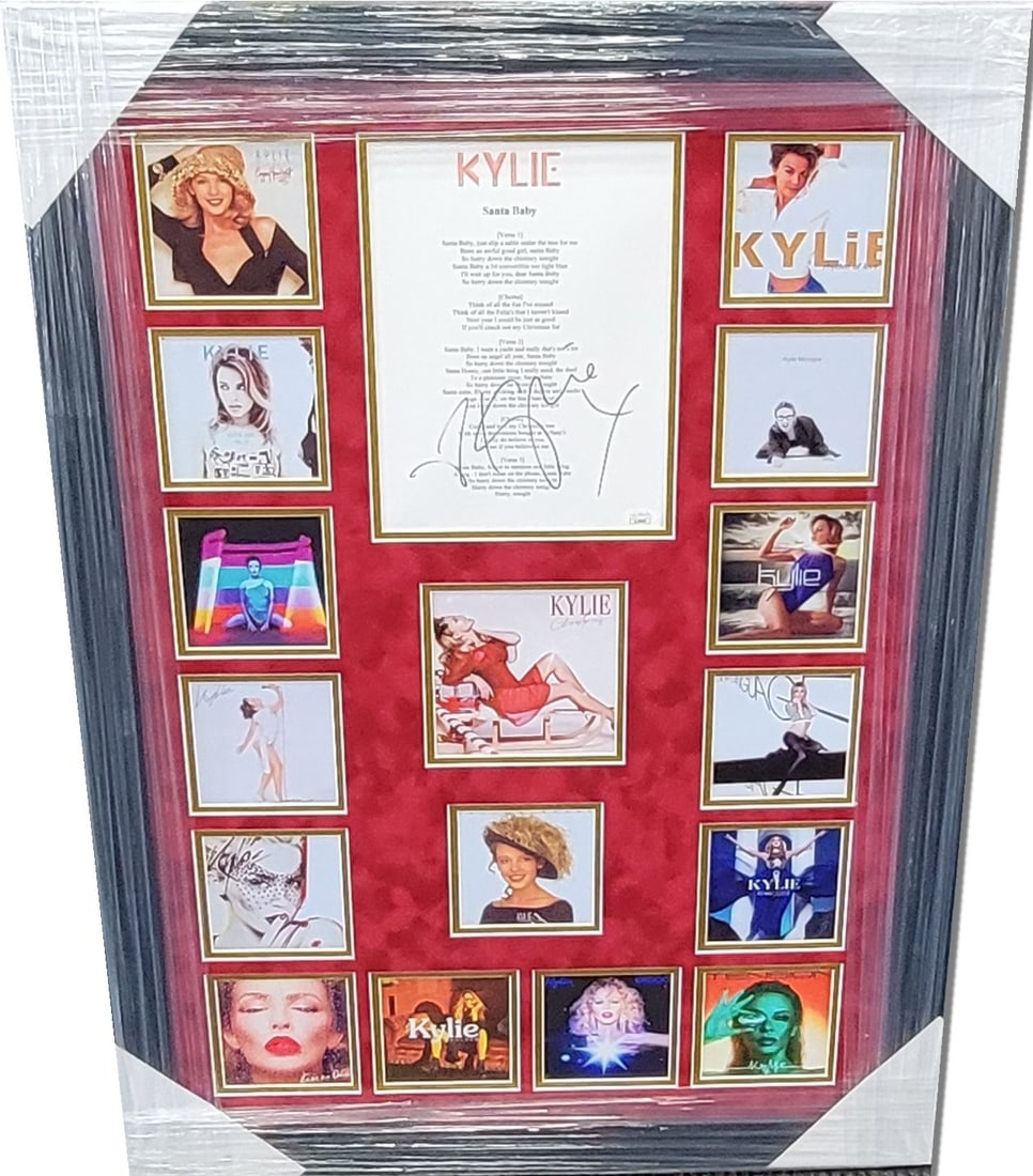 Kylie Minogue Santa Baby Signed Script Collage 26x36 Framed JSA Authenticated: Kylie Minogue Santa Baby Signed Script Collage 26x36 Framed JSA Authenticated This unique framed collage features a hand-signed script of Kylie Minogue's "Santa Baby," making it a perfect collectible