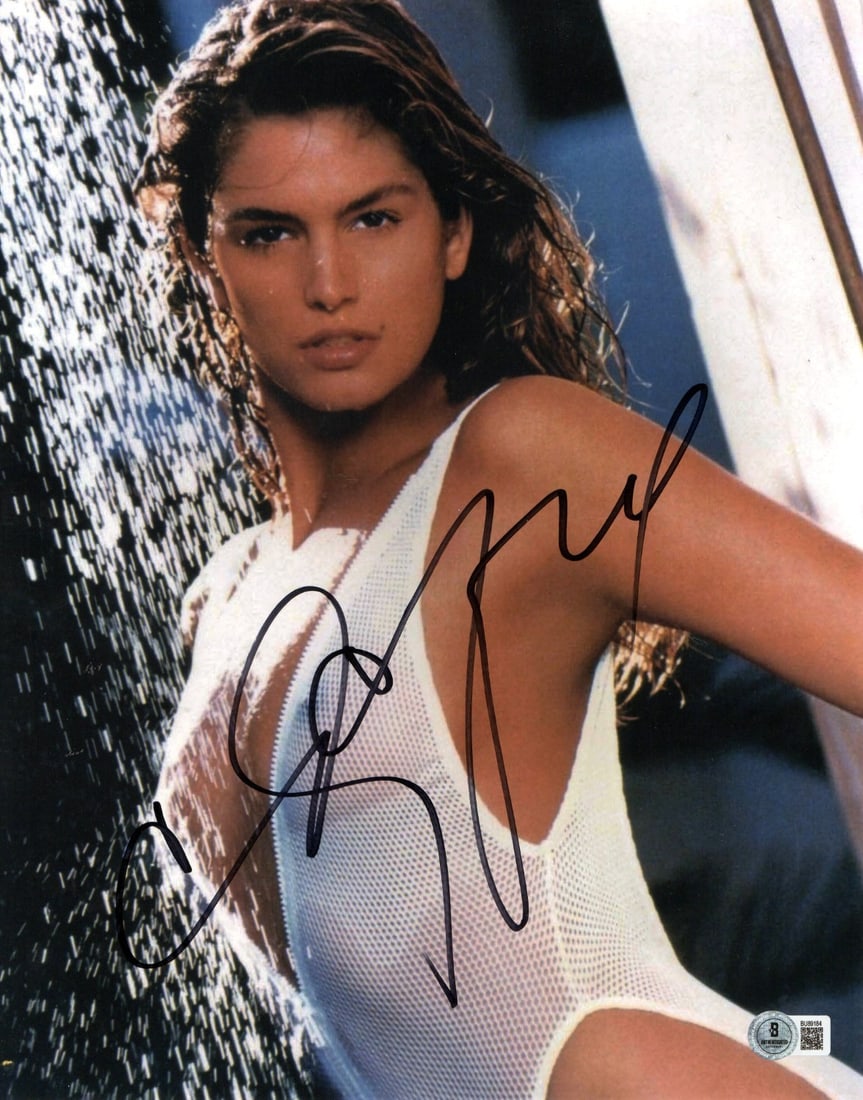 Cindy Crawford Signed 11x14 Photo Beckett Authenticated Supermodel: Cindy Crawford Signed 11x14 Photo Beckett Authenticated Supermodel This stunning 11x14 photograph features the iconic supermodel Cindy Crawford in a glamorous shower scene. The image is an authentic r