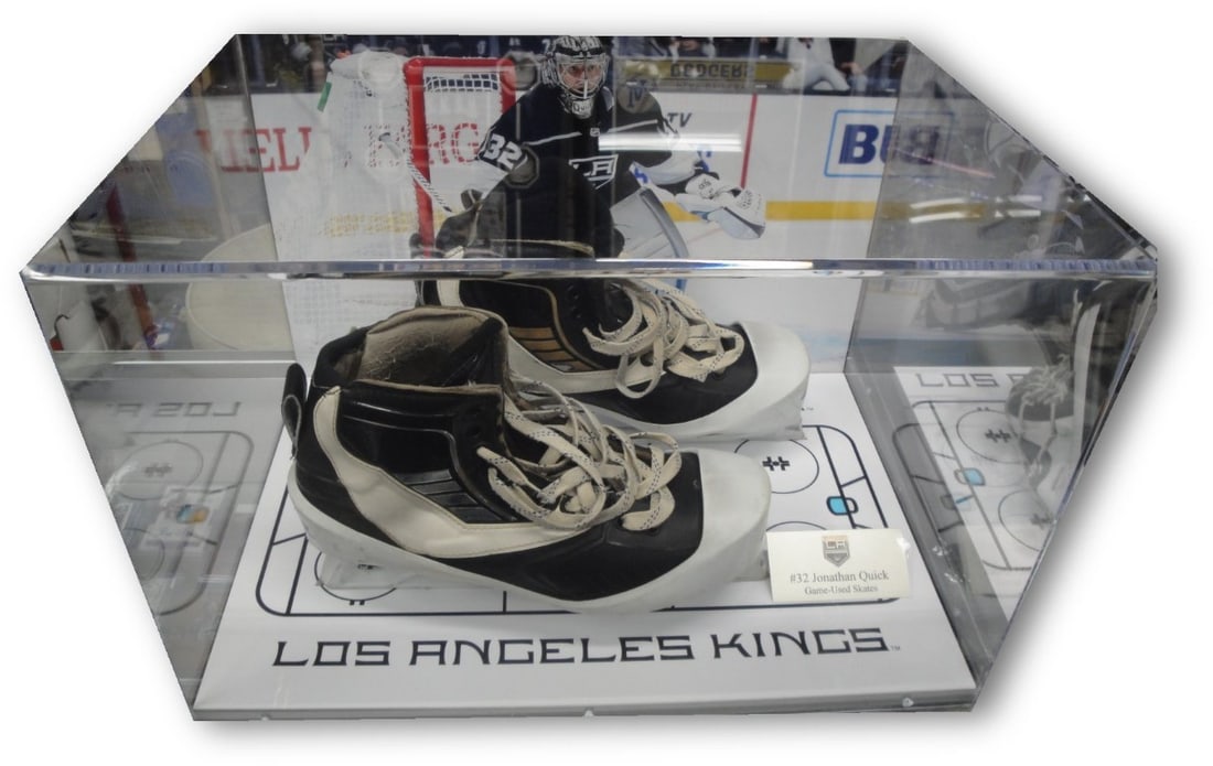 Jonathan Quick Game Used Skates in Los Angeles Kings Shadowbox: Jonathan Quick Game Used Skates in Los Angeles Kings Shadowbox This is a stunning display featuring game-used skates from Jonathan Quick, the renowned goaltender of the Los Angeles Kings. The skates a