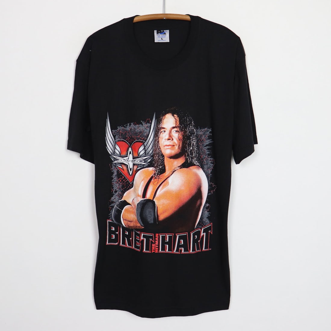 Vintage 1990s Bret The Hitman Hart Black Cotton Graphic T Shirt: Vintage 1990s Bret The Hitman Hart Black Cotton Graphic T Shirt This is an original vintage 1990s Bret The Hitman Hart shirt featuring graphic designs on both the front and back. Made from 100% cotton