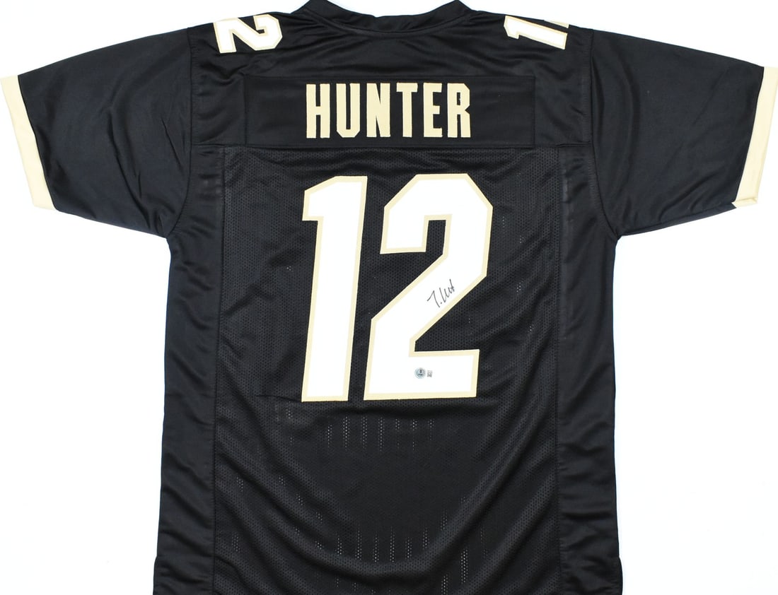 Black College Jersey Signed by Travis Hunter with Beckett W Hologram: Black College Jersey Signed by Travis Hunter with Beckett W Hologram This black college style football jersey features the autograph of Travis Hunter and represents the Colorado Buffaloes. It is an or