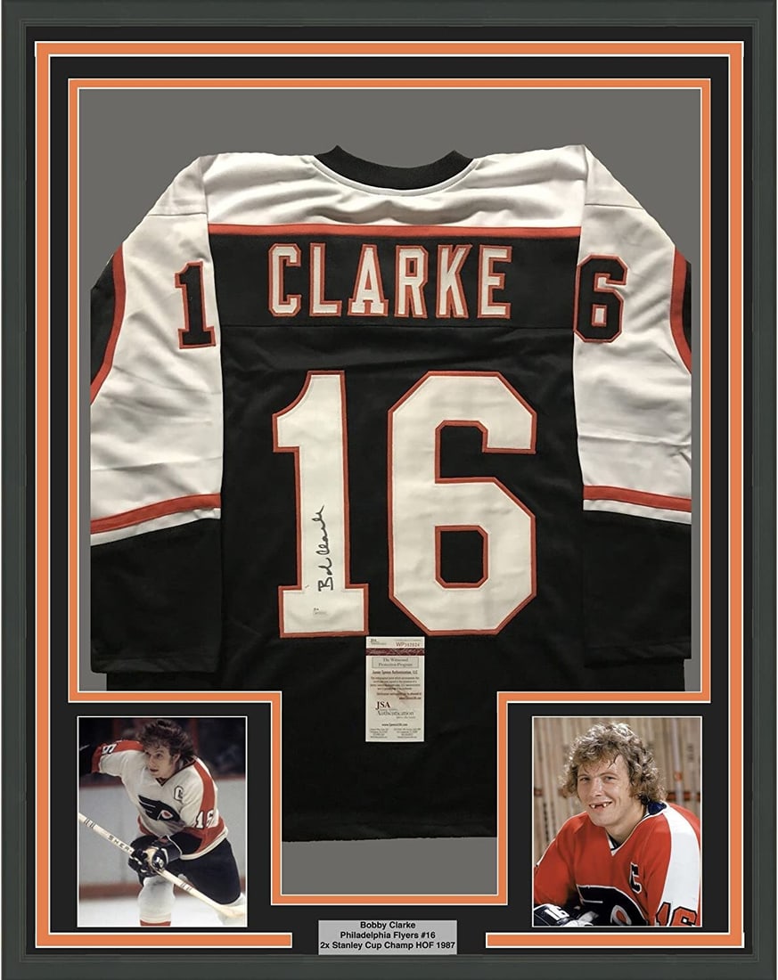 Framed Signed Bobby Clarke Philadelphia Flyers Jersey with JSA COA: Framed Signed Bobby Clarke Philadelphia Flyers Jersey with JSA COA Celebrate the legacy of Bobby Clarke, a legendary player of the Philadelphia Flyers, with this professionally framed and autographed